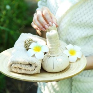 female-hands-with-tray-spa-products-green-reeds-river_392895-99536